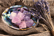 A Top View Image Of Rose Quartz Healing Crystal In An Abalone Shell With Dried Lavender Flowers. 