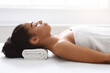 Joyful african american woman resting after healing massage