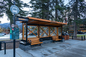 Wall Mural - Street view of Town of Banff. Bus stop in Banff Avenue in autumn and winter snowy season. Banff, Alberta, Canada.