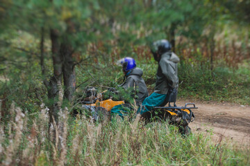 Wall Mural - Group of riders riding atv vehicle on off road track, process of driving ATV vehicle, all terrain quad bike vehicle, during offroad competition, crossing a puddle of mud