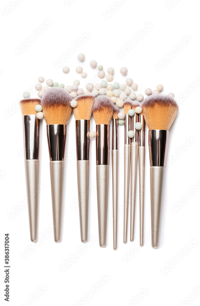 Set of makeup brushes with powder pearls on white background - obrazy, fototapety, plakaty 