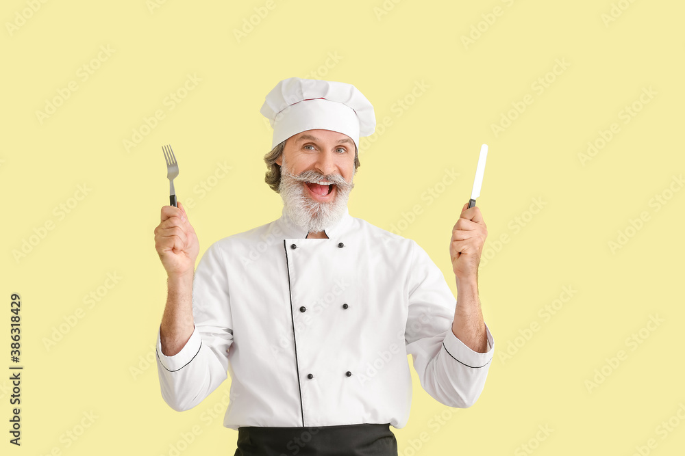 Mature male chef on color background