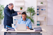 © Elnur - Old boss and his young assistant in the office