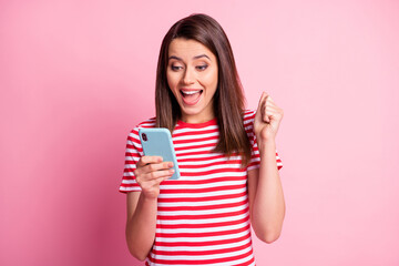 Sticker - Photo of astonished nice young brunette lady look gadget wear casual outfit isolated over pastel pink background