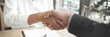 © mojo_cp - Lawyer consultant shaking hand with client in law firm.