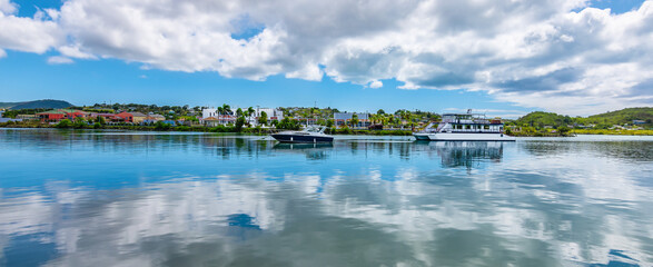 Fototapete - Green Bay of St John's, Antigua and Barbuda. Panoramic view of the harbour bay with boats and reflection of the clouds in the water.