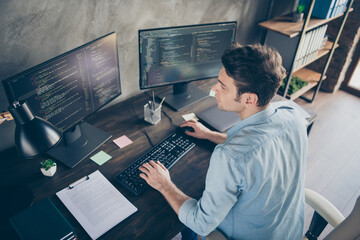 top above high angle view portrait of his he nice attractive focused skilled geek guy typing bug tra