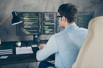 rear back behind view portrait of his he nice skilled focused busy geek guy typing creating database
