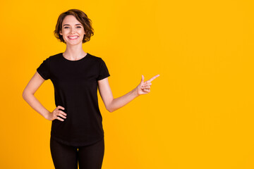 Poster - Portrait of nice-looking lovely content cheerful girl pointing aside copy space solution isolated bright yellow color background