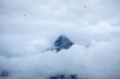 peak of mount vrh brda in bewteen clouds