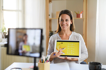 Wall Mural - Woman teacher teaching online, coronavirus and online distance learning concept.