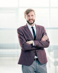 Wall Mural - portrait of a confident business man on an office background.