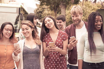 Happy friends using smartphones. Young students people having fun with technology. Friendship and university concept.