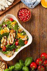 Wall Mural - Traditional Greek salad with grilled Halloumi cheese with basil. Top view. Flat lay.