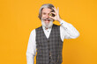 © ViDi Studio - Funny elderly gray-haired bearded business man in checkered waistcoat shirt covering eye with bitcoin coin currency isolated on yellow background studio portrait. Achievement career wealth concept.