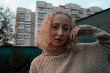 Portrait of a girl on the background of a high-rise building