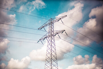 Power line tower with clouds in the background