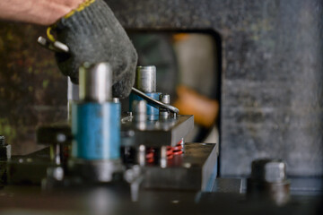 Worker repair machine with wrench in maintenance service