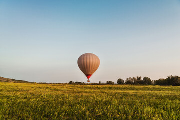 Hot air balloon in the sky low above the ground