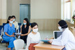 © JuYochi - Many people wearing a surgical mask comes to the hospital for examination.