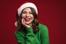 Beautiful Happy Girl In Santa Claus Hat Smiling And Looking At Camera