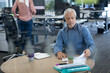 © WavebreakMediaMicro - Senior businessman wearing headset looking at documents at office