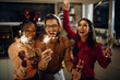 © Drazen - Group of happy friends having fun on New year's party at home.