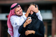 © manowar1973 - Portrait of Arabic dressed yang couple play with mobile phone