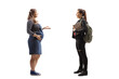 © Ljupco Smokovski - Full length profile shot of a young pregnant woman talking to a female student with a backpack and books