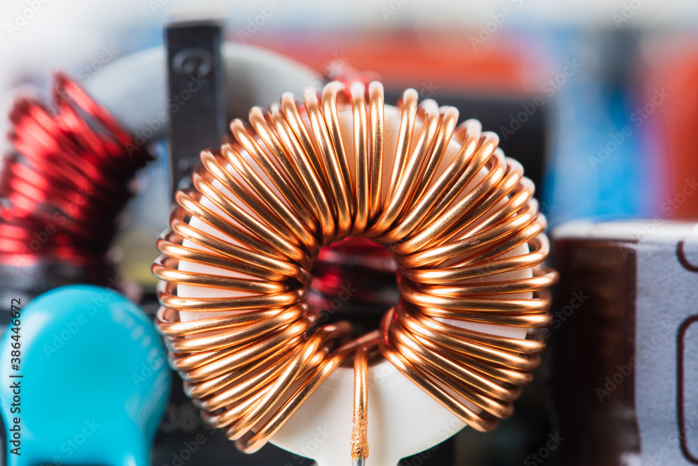 Electromagnetic Inductor copper wire winding on circuit board close-up ...