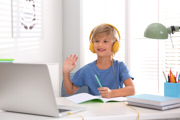 Canvas Print - Little boy studying online at home. Distance learning during COVID-19 pandemic