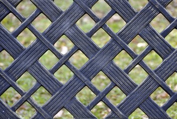 Closeup of a cross pattern on weathered forged iron fence, nice  aged patina