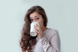 © Юлия Завалишина - Beautiful young brunete woman with take away paper coffee cup isolated on white background. Happy smiling girl having lunch break. Morning drink resting leisure concept