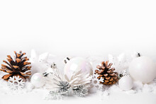 Silver And White Christmas Balls And Ornaments On White Snow Background
