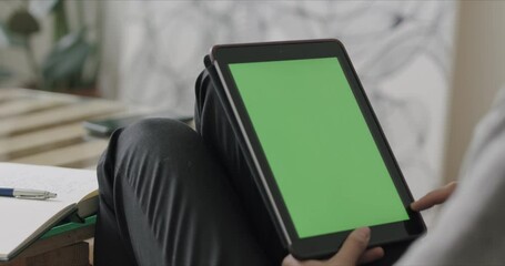 Wall Mural - Woman holding tablet computer with green screen