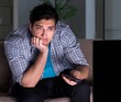 © Elnur - Young man watching tv late at night