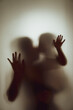 © releon8211 - Concept shadow of Mother and child kissing the matte glass blurry hand and body soft focus