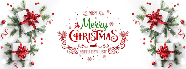 merry christmas text on white background with gift boxes, ribbons, red decoration, fir branches, bok