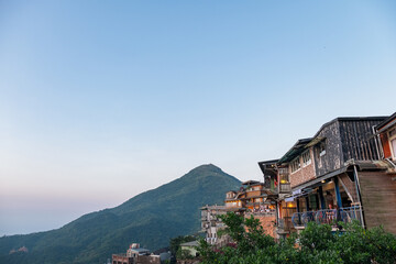 Sticker - Landscape view of teahouse and mountain at Juifen Village.