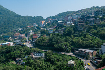 Poster - landscape view of JiuFen Village with mountain residental buildings and blue sky.