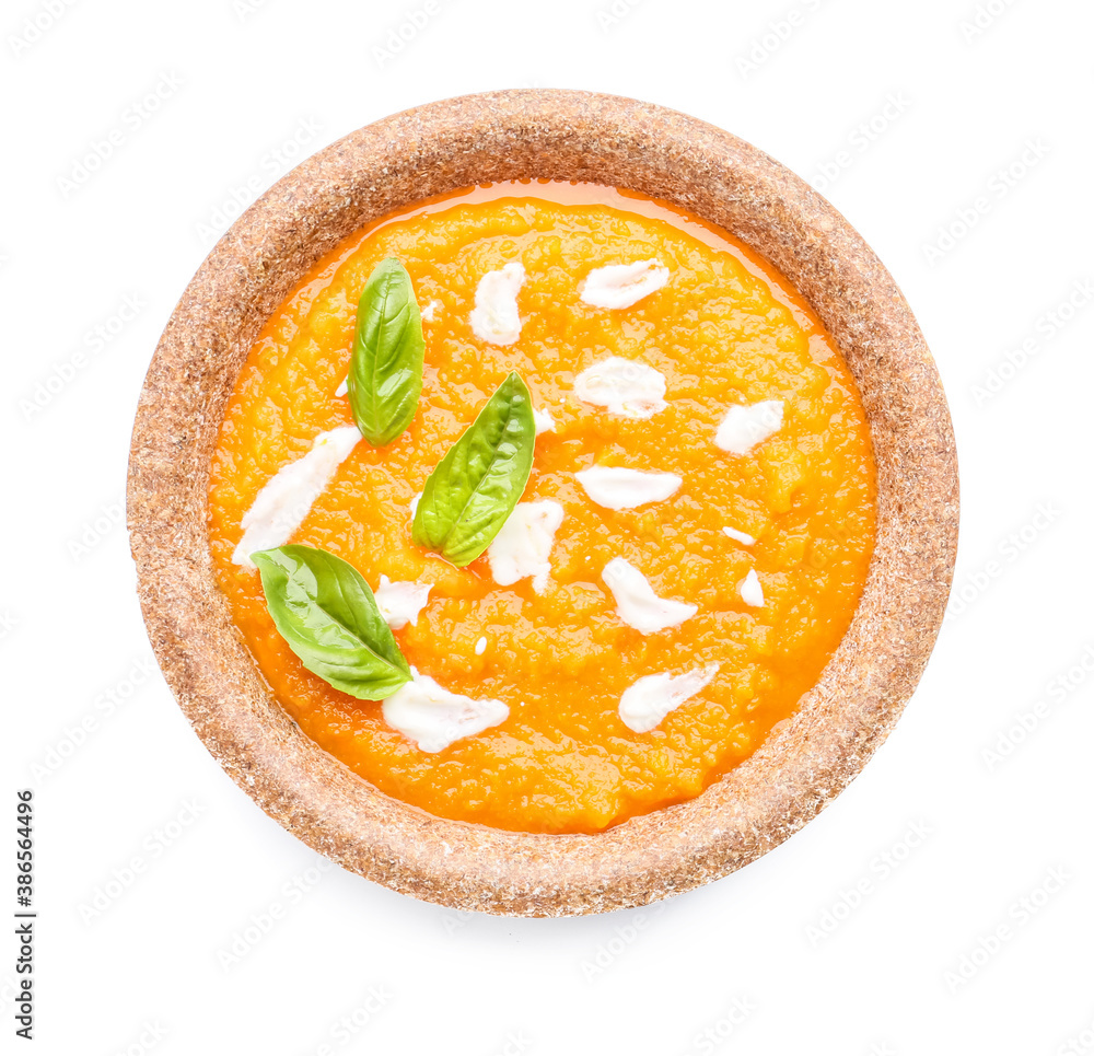 Tasty pumpkin cream soup in bowl on white background
