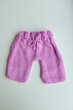 © develi - Various colors and types of cotton clothing, knitted newborn clothes and newborn hats on a white background.