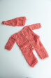 © develi - Various colors and types of cotton clothing, knitted newborn clothes and newborn hats on a white background.