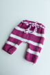 © develi - Various colors and types of cotton clothing, knitted newborn clothes and newborn hats on a white background.
