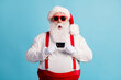 © deagreez - Photo of pensioner grandfather grey beard hold debit card suggest advice shopping service wear santa x-mas costume red suspenders sunglass white gloves cap isolated blue color background