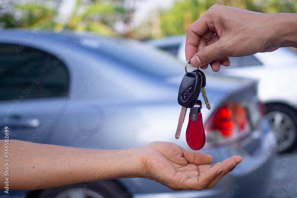 Sales agencies are selling cars and giving keys to new owners. sell car or rental car - obrazy, fototapety, plakaty 