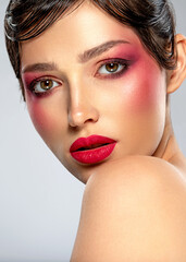 Wall Mural - Beautiful brunette girl with bright eye makeup. Beautiful fashion woman with  a red lipstick on her lips. Glamour fashion model with vivid make-up. Stylish fashionable concept. Art. Beauty  face.