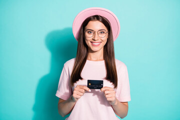 Poster - Portrait of her she nice attractive cheerful cheery girl client holding in hands pay pass card spend money retail store isolated bright vivid shine vibrant green turquoise color background