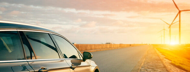 The car stretches out the sunset horizon