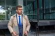 © Red Riding Hood - A businessman with glasses leaves the office with a laptop in his hands.